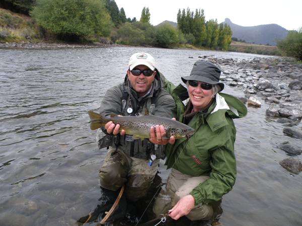 Sue with her guide Diego and a big brown trout from the Traful River